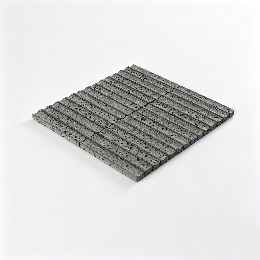 Angled view of grey lava stone linear mosaic tile.