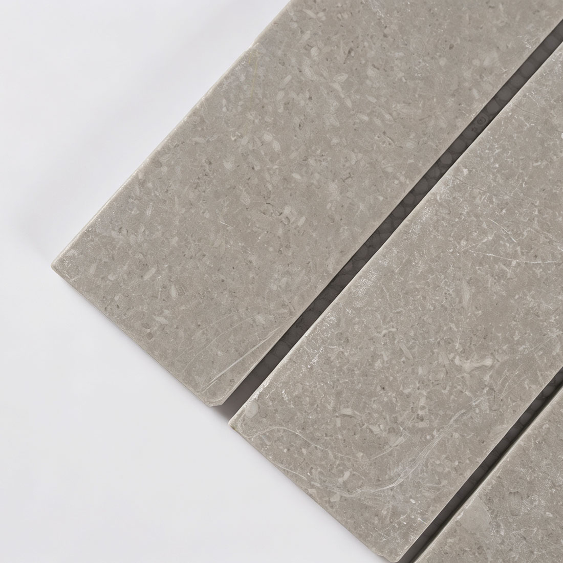 Close-up texture of grey marble strip tile with white veining