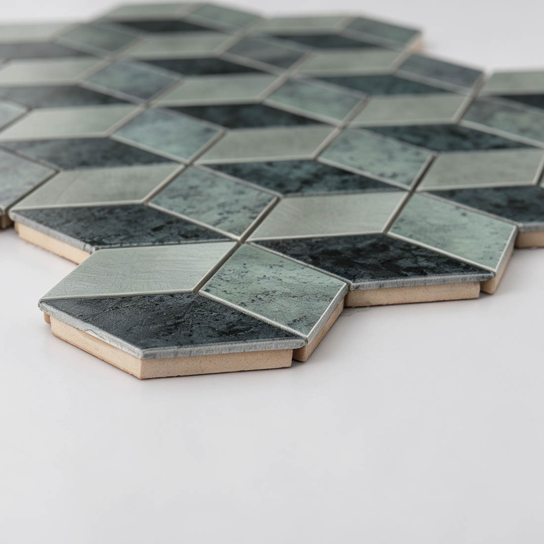 Side view of grey silver aluminum cube mosaic tiles showing geometric faces and tile thickness