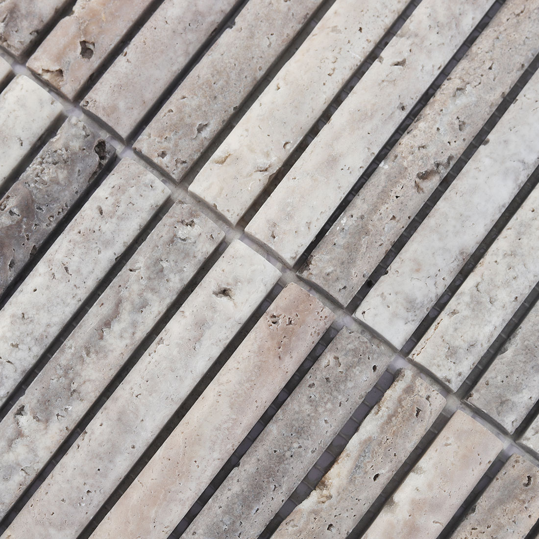 Surface texture and natural pitted patterns of grey travertine stone.