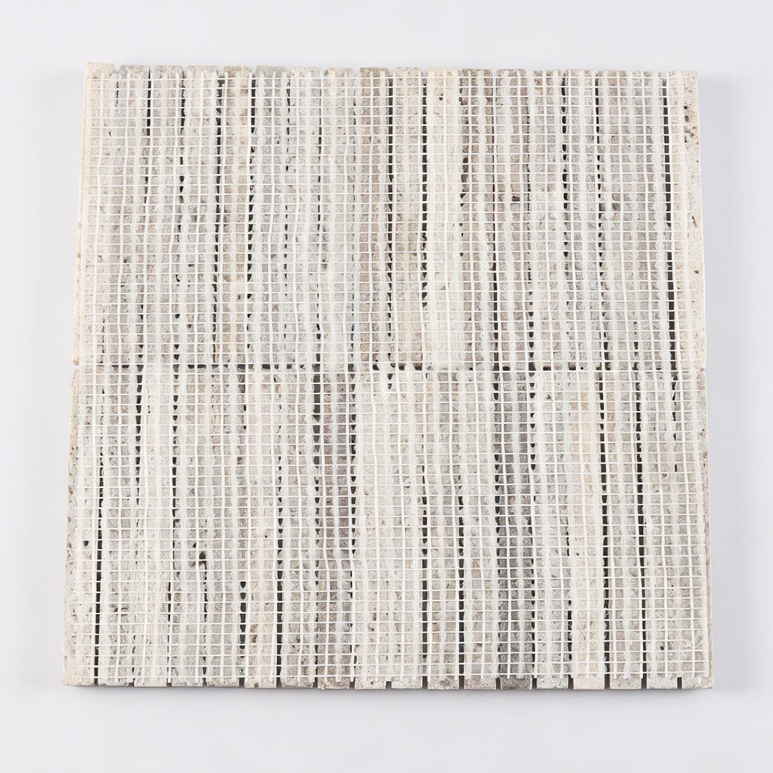Professional mesh-mounted backing of grey travertine semi-circle rod mosaic tile.