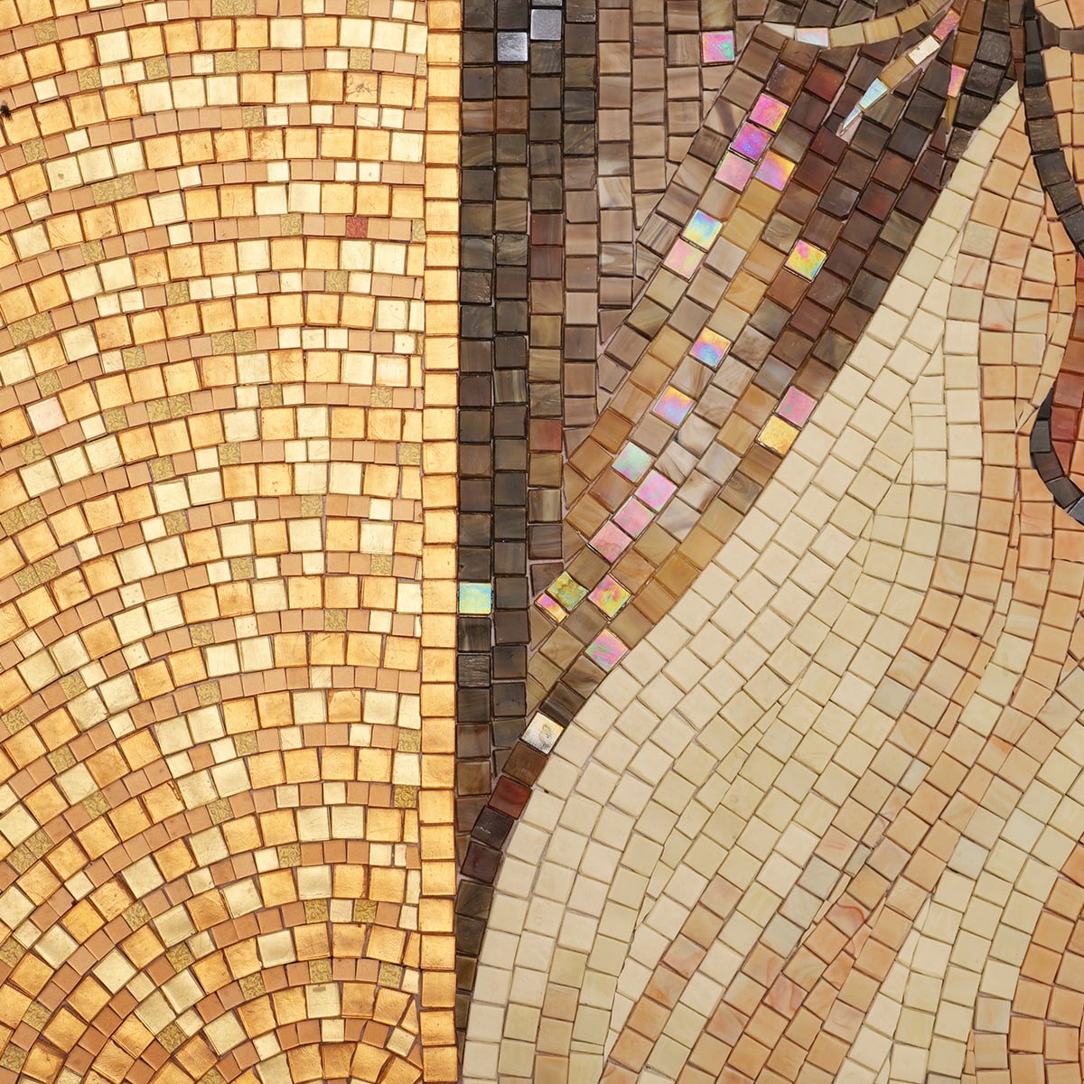 Detailed view of handcrafted mosaic tiles in warm gold and beige tones.