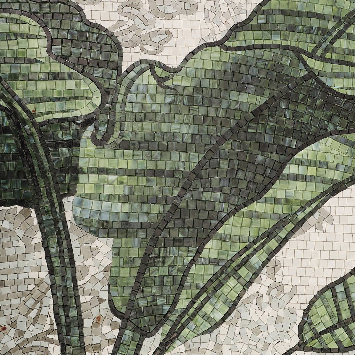 Detailed texture of handmade mosaic banana leaves in green tones.