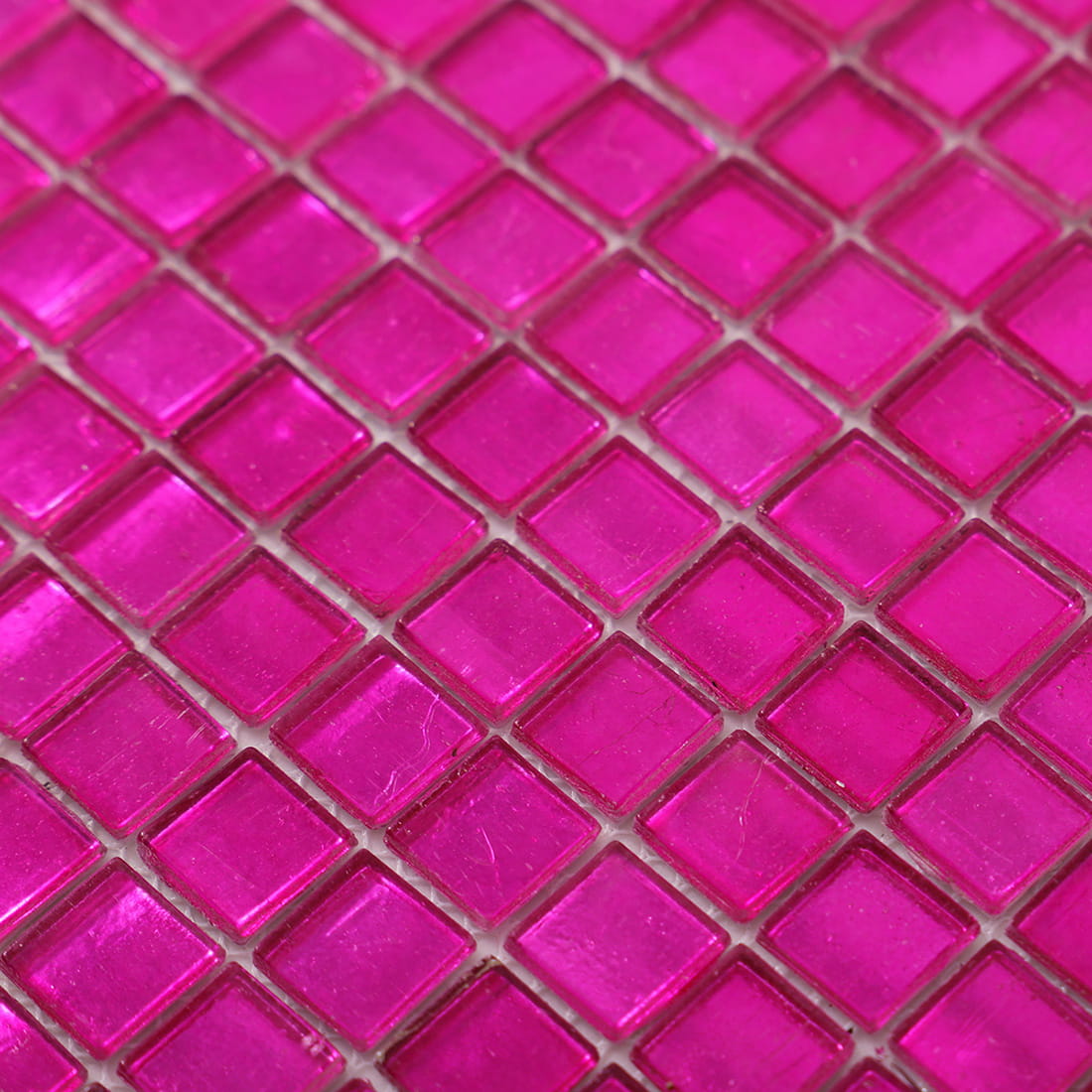Close-up of hot pink foil-backed square glass mosaic 
