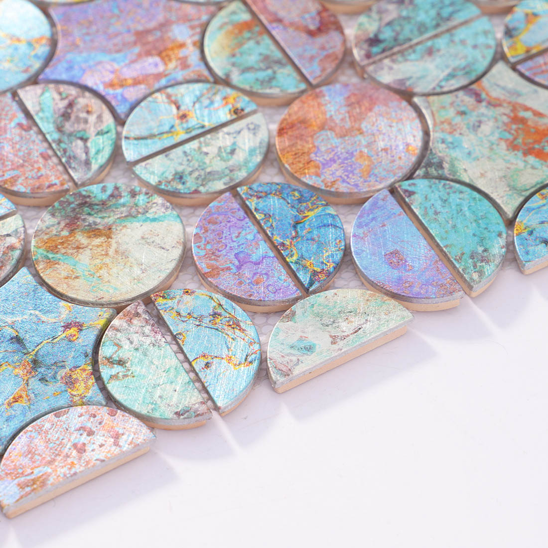 Angle shot of iridescent round mosaic tile showing metallic aluminum edge