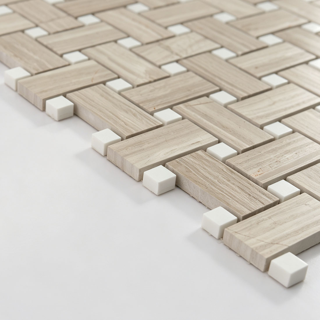 Angled view of ivory greige marble basketweave mosaic tile with white accents
