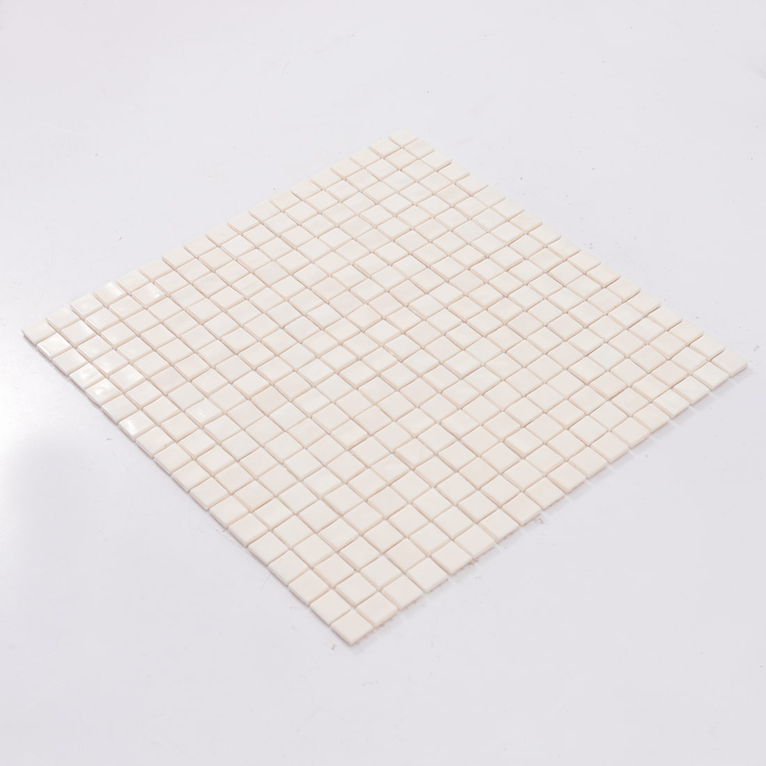 Angled sheet view of light blush pink square glass mosaic