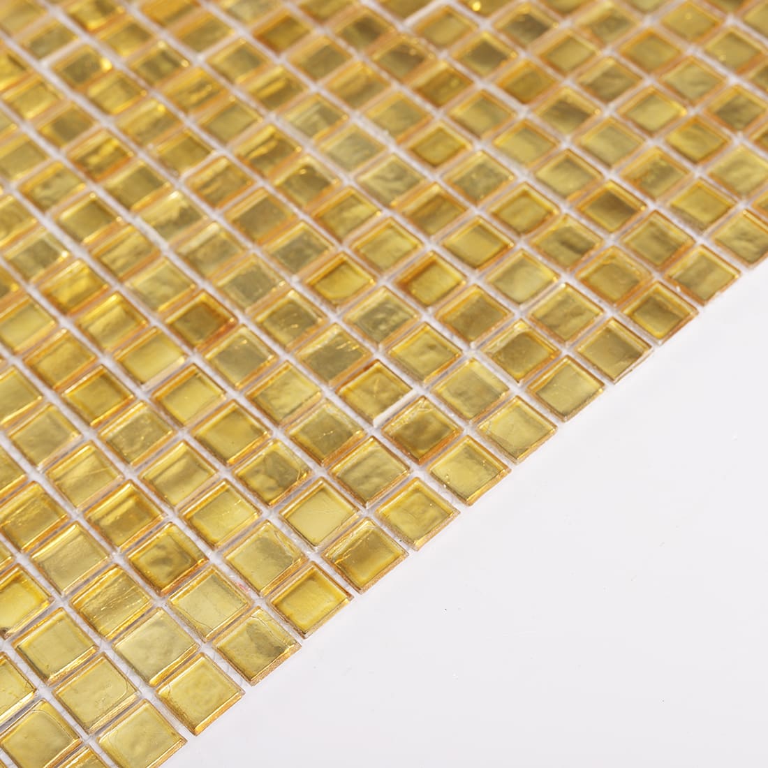Angled detail of light gold square glass mosaic tile sheet