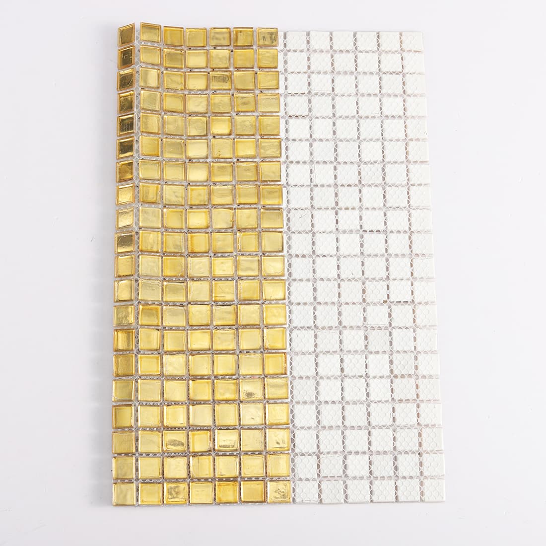 Back view of light gold square glass mosaic tile with mesh backing