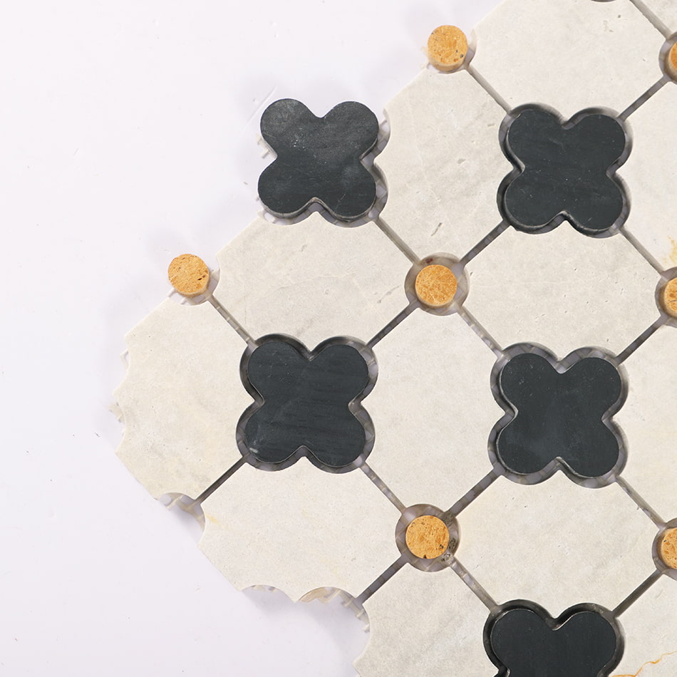 Corner detail of light gray marble mosaic with black quatrefoil and yellow dots