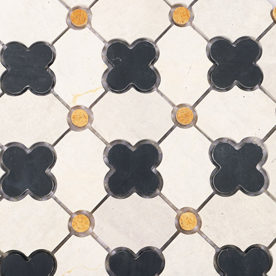Close up of light gray marble mosaic pattern with black quatrefoil and yellow dots