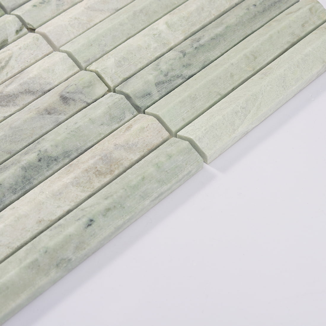 Close-up of light green marble fluted mosaic tile surface
