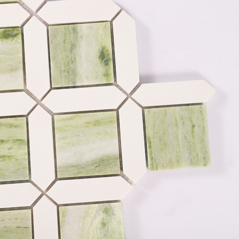 Corner detail of light green marble and white geometric mosaic tile