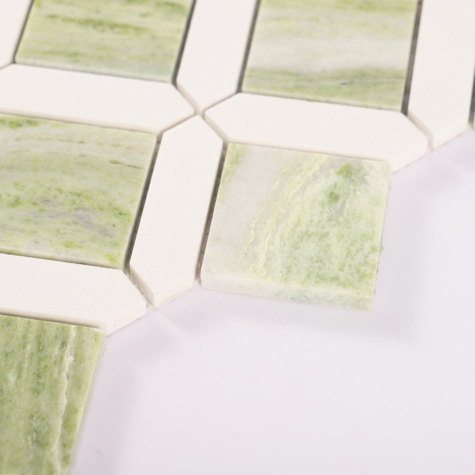 Edge detail of light green marble and white geometric mosaic tile