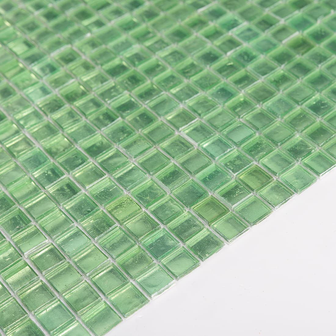 Side view showing the thickness of light green square glass mosaic tile