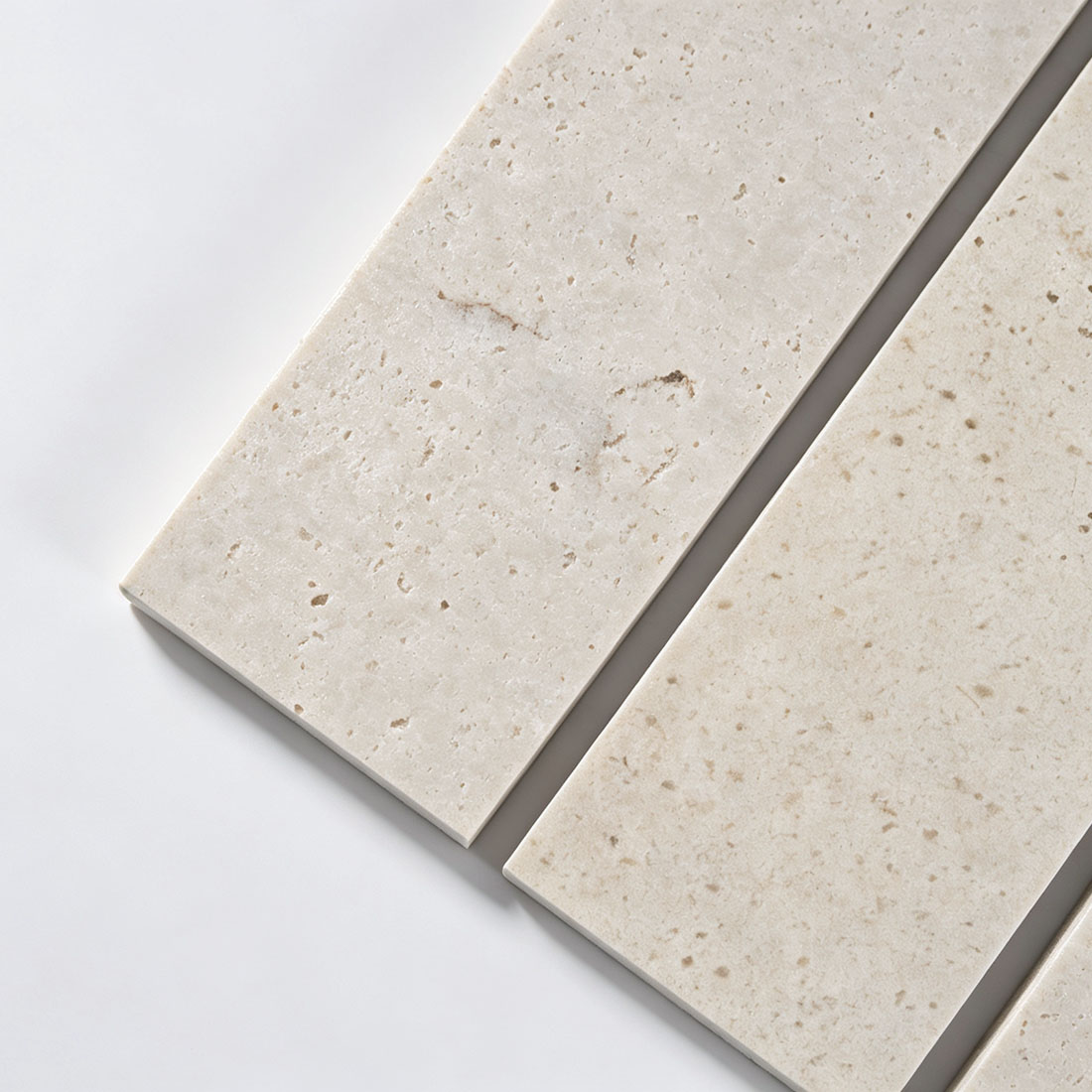 Close-up texture of light grey marble strip tile with natural veining