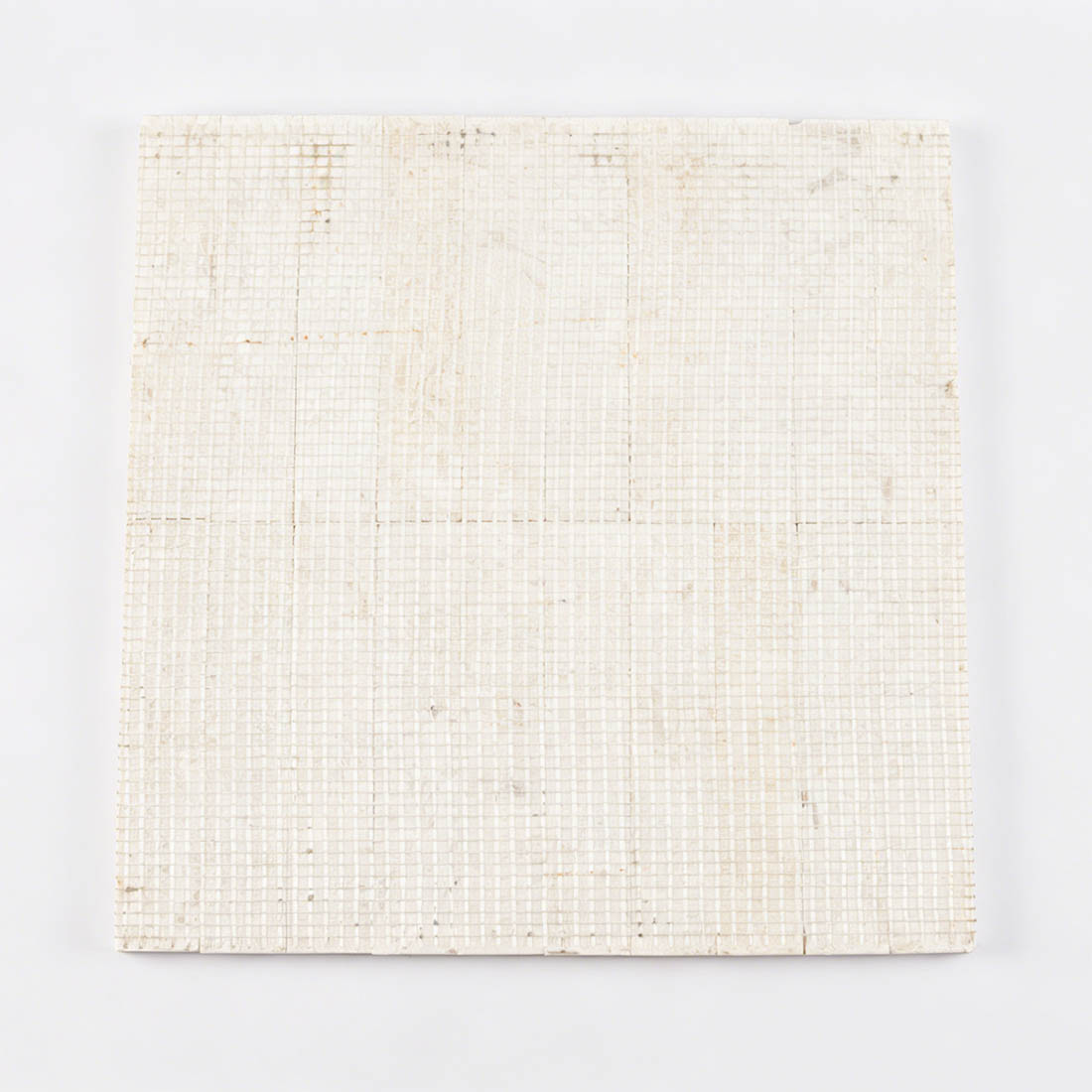 Professional mesh-mounted backing of seamless beige limestone wave tile.