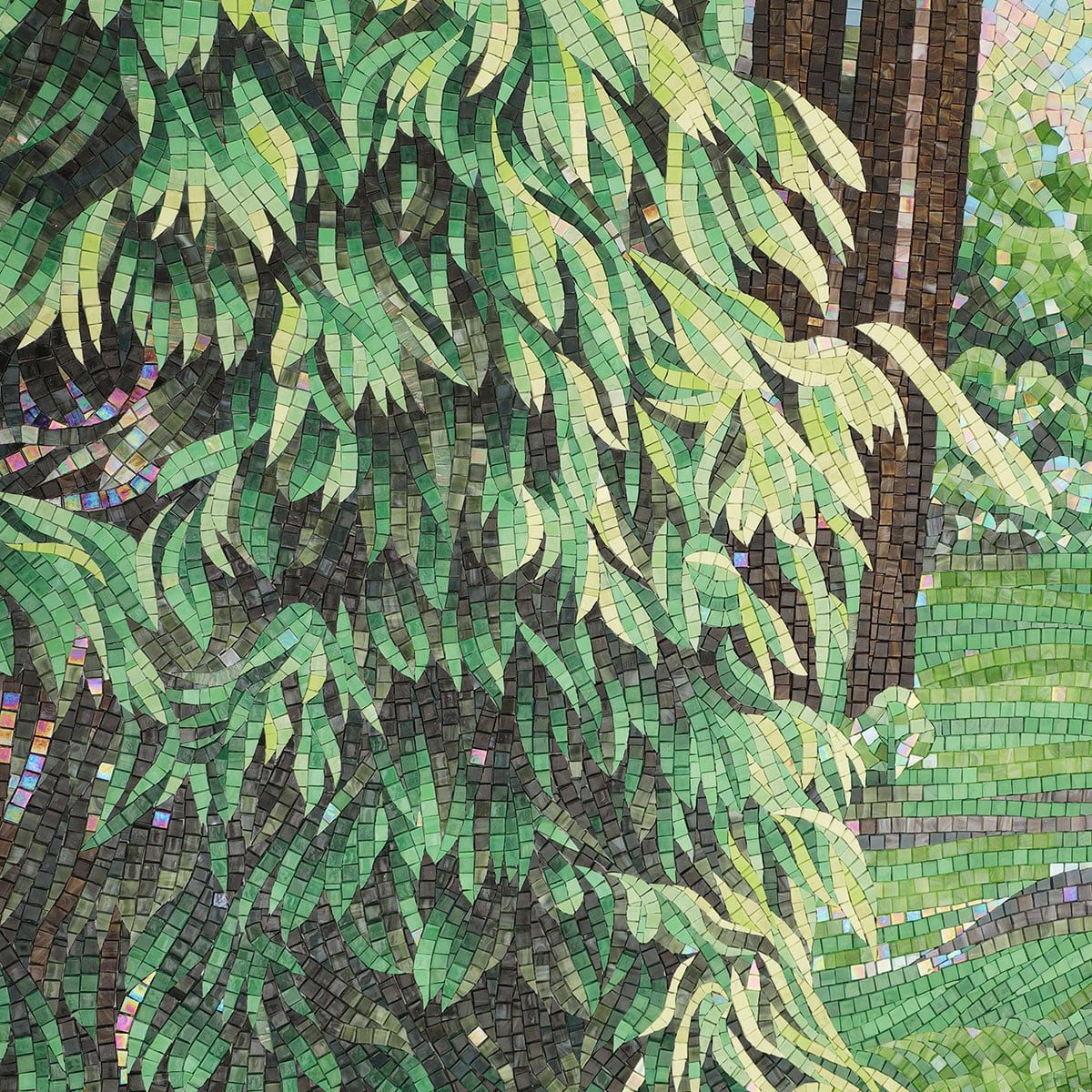 Detailed mosaic wall art showing green foliage and tree trunks made from small square tiles.