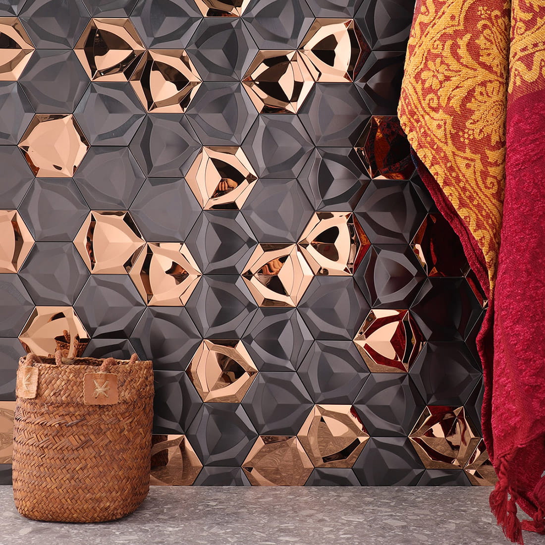 Luxury wall installation of rose gold and black hexagon tiles with decor.