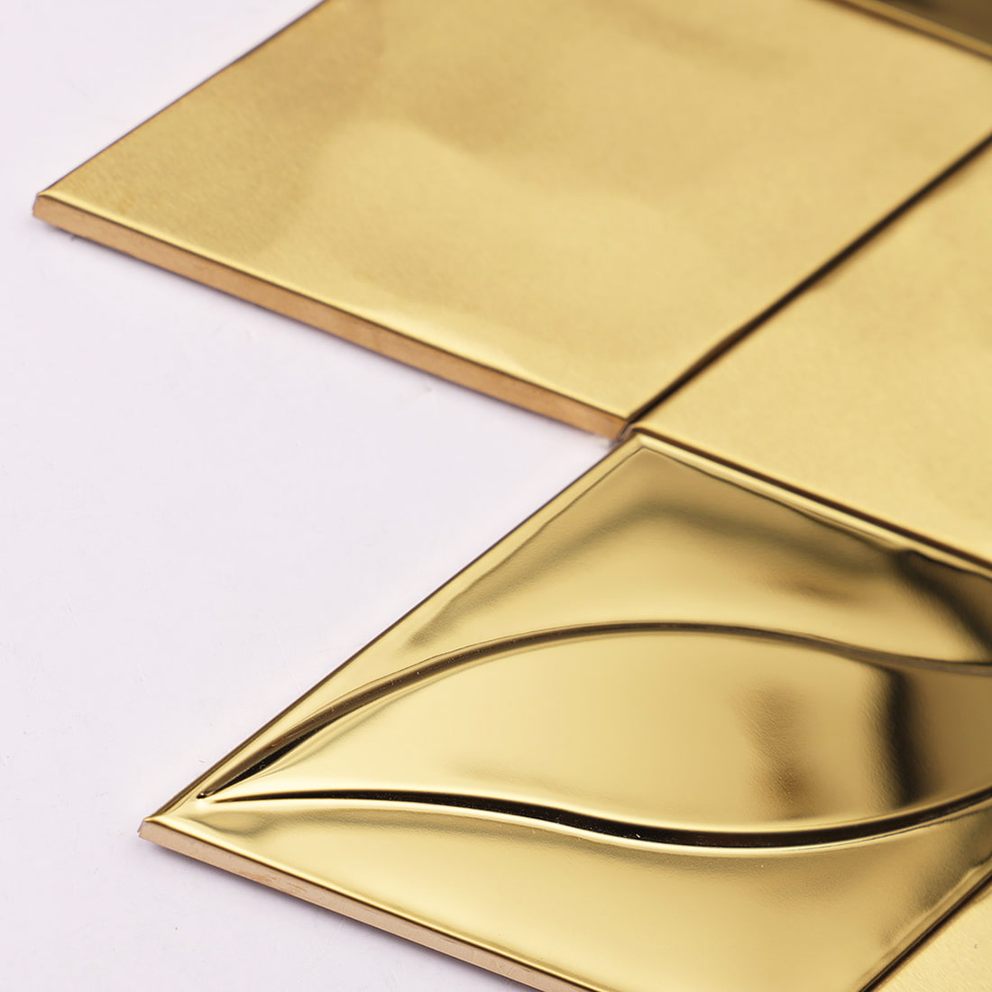 Macro view highlighting the 3D glossy edge of a gold leaf patterned tile