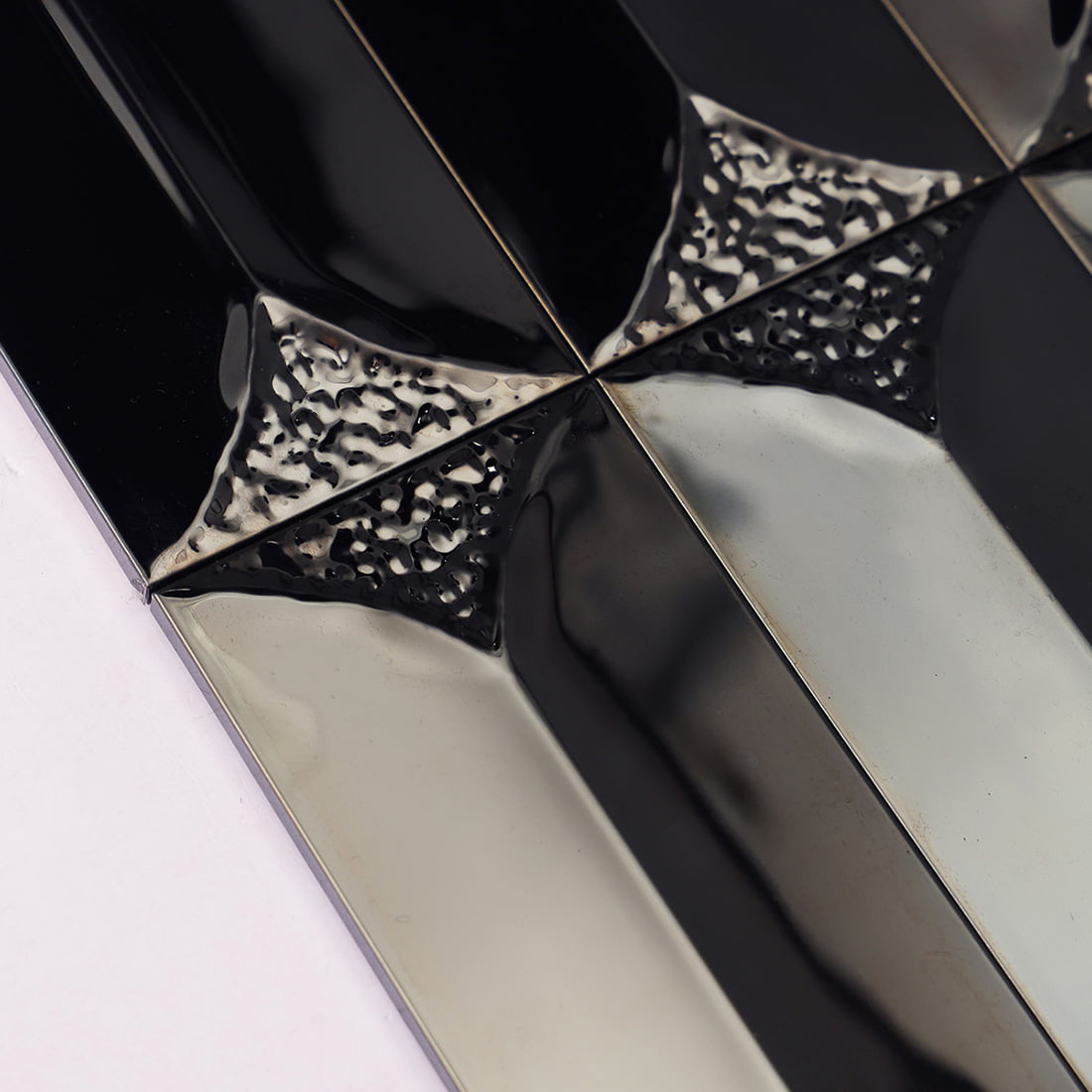 Extreme close-up of the pebbled texture on black metal tiles.