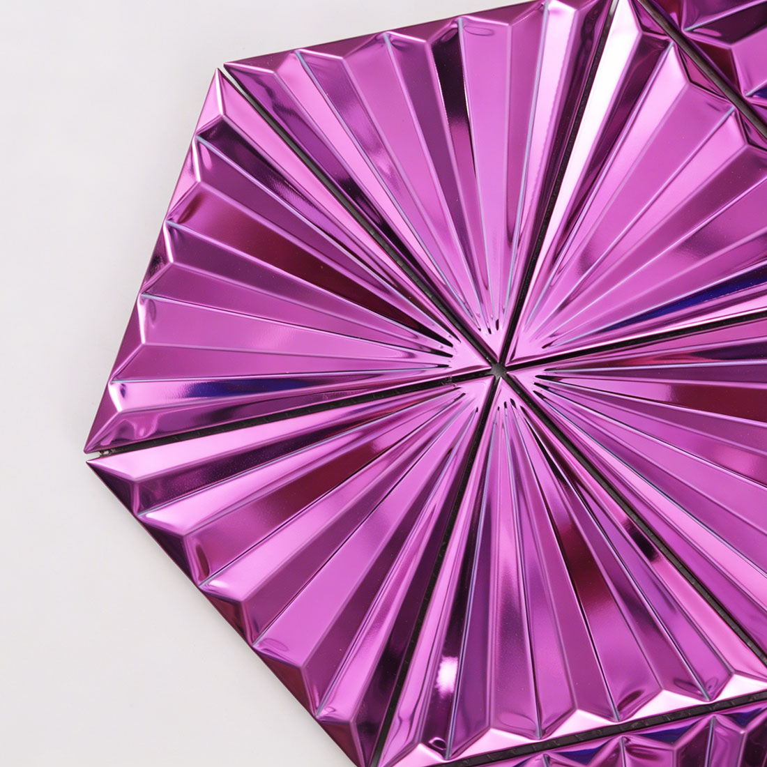 Close view of magenta fan triangle metal mosaic with raised rib texture