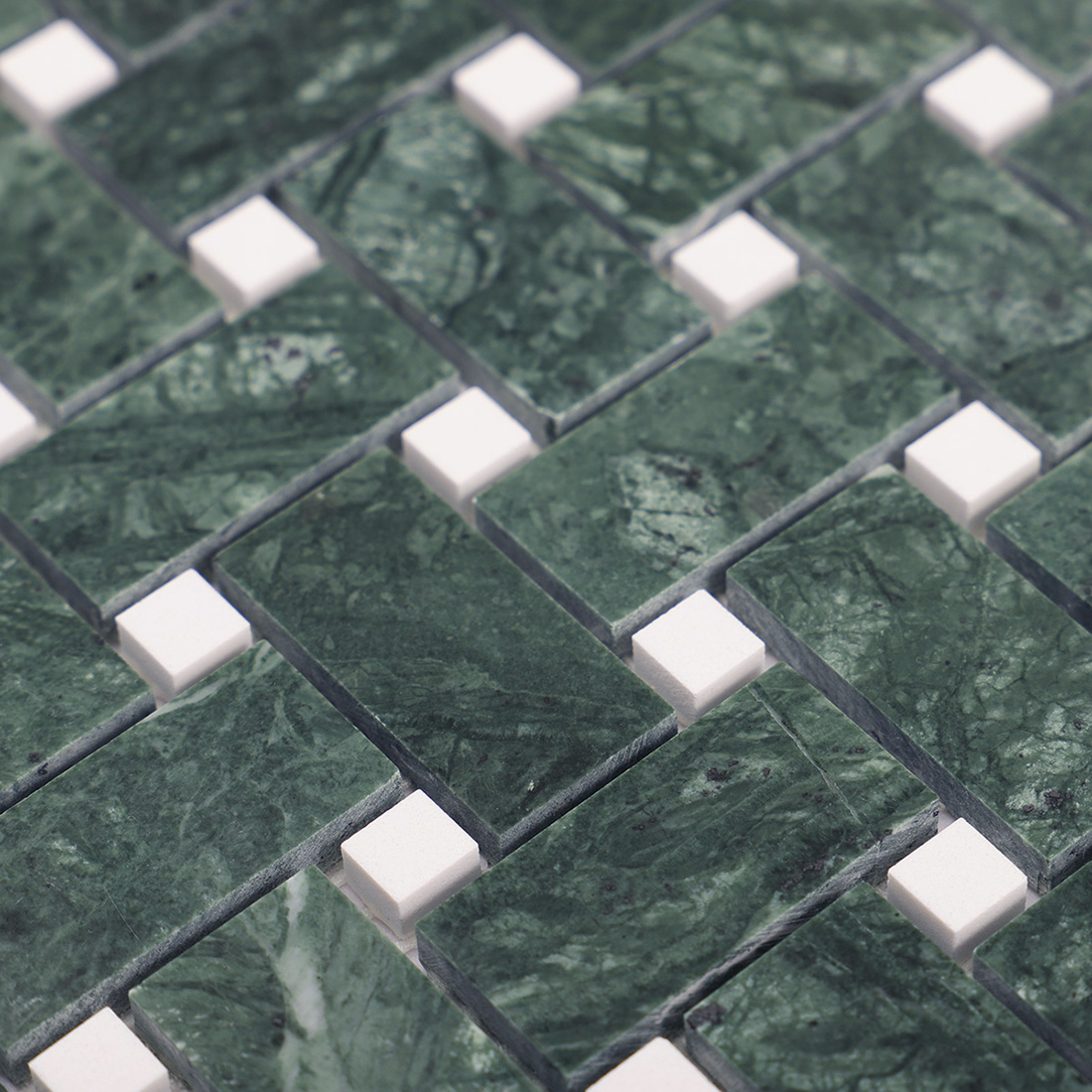 Macro shot of white marble square dots in a green basketweave mosaic.