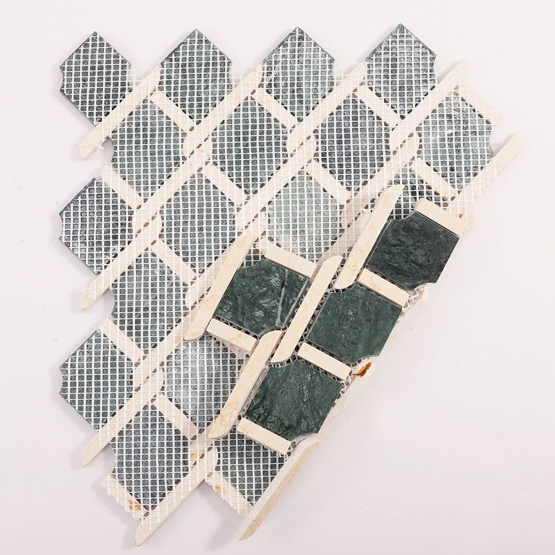 Back view of green and beige marble chain link mosaic tile with mesh backing