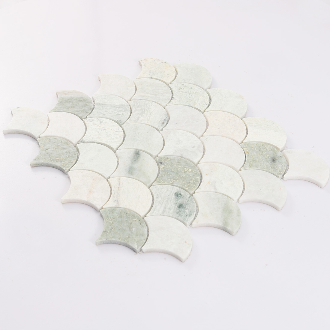 Angled view of light green marble fan mosaic tile.