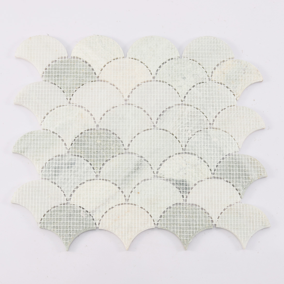 Mesh backing on the reverse side of marble fan mosaic.