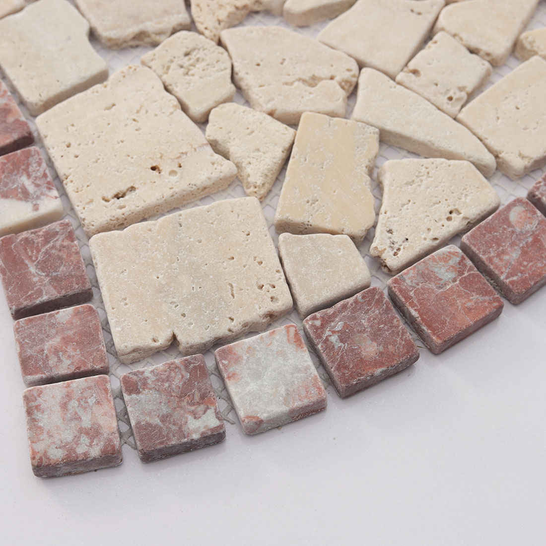 Close-up of the red marble border and beige center stones.