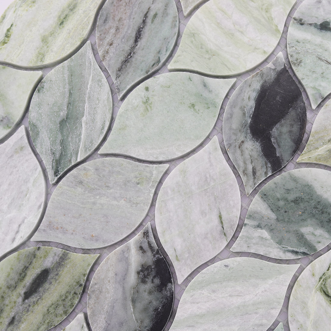 Detailed texture of light green marble leaf mosaic.