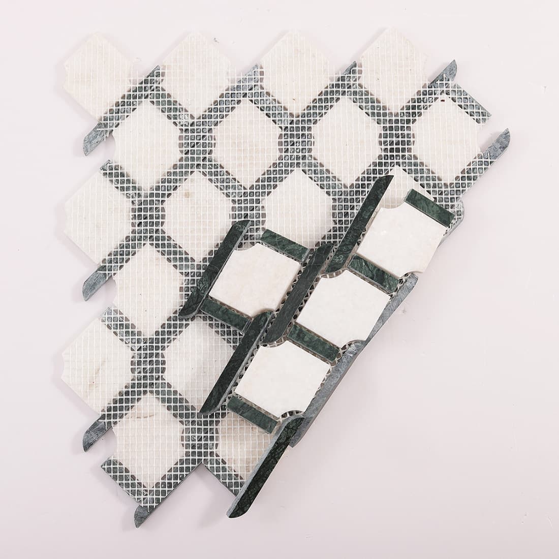 Back view of green and white marble mosaic tile with mesh backing