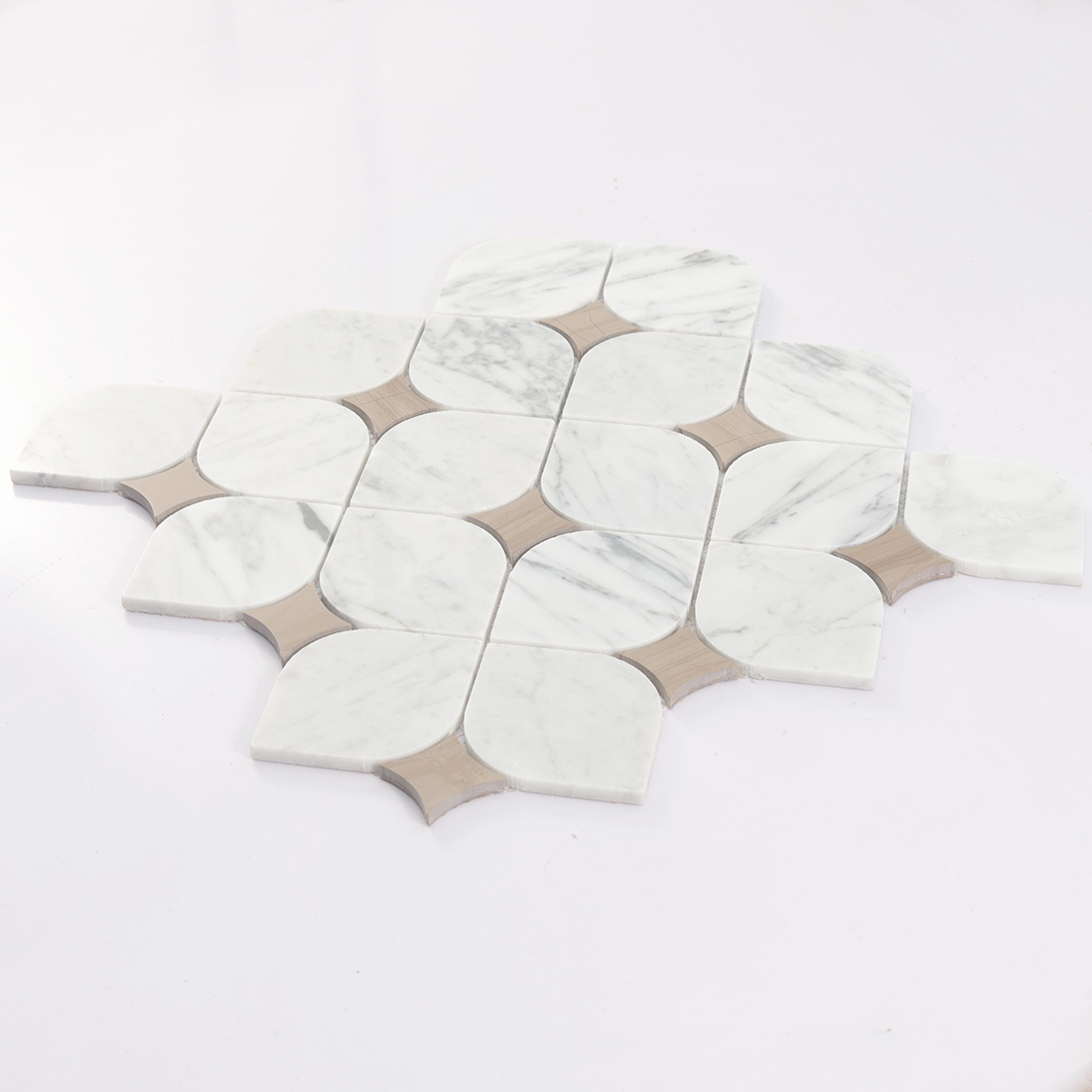 Angled view of white and beige marble petal mosaic.