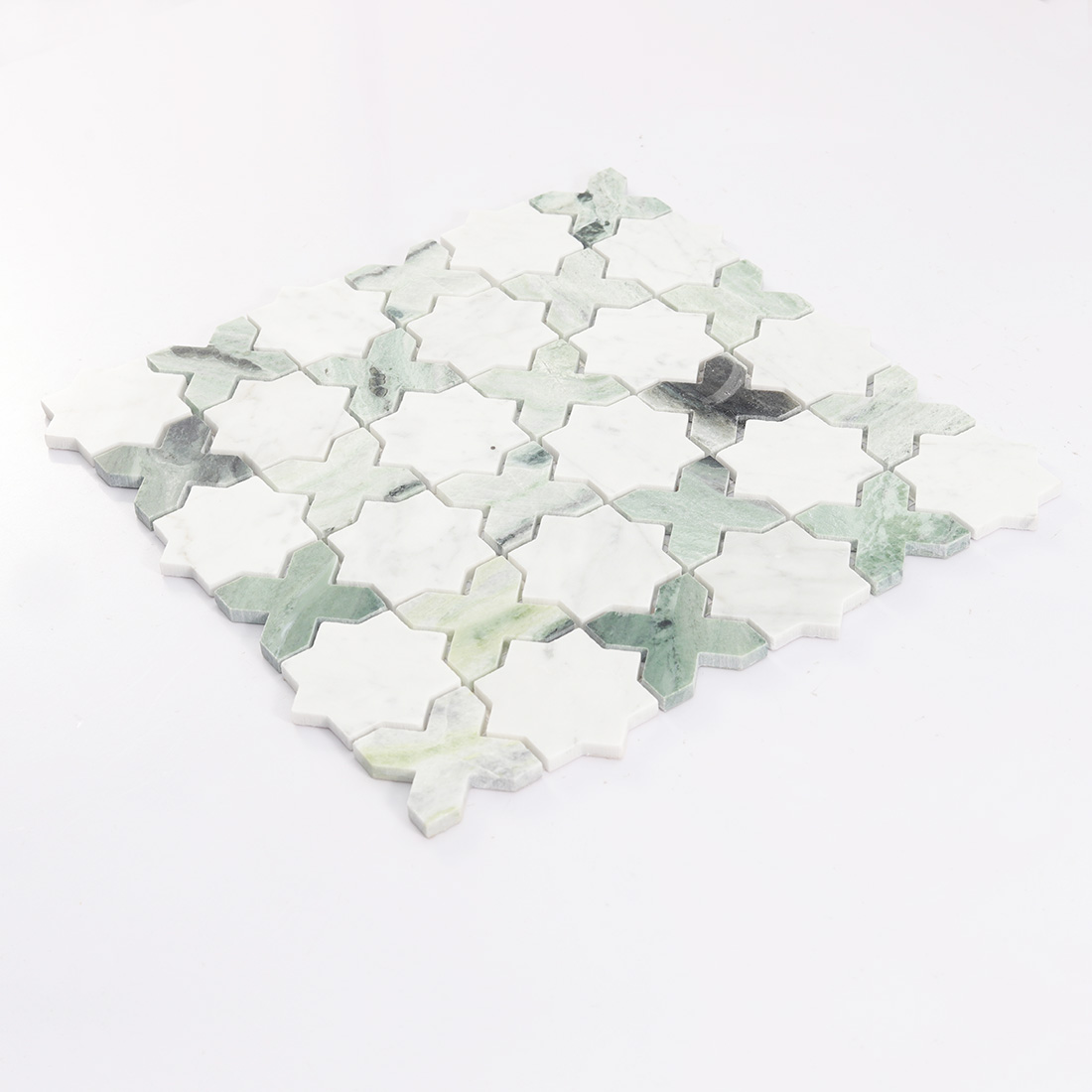 Angled view of white and green marble star cross mosaic.