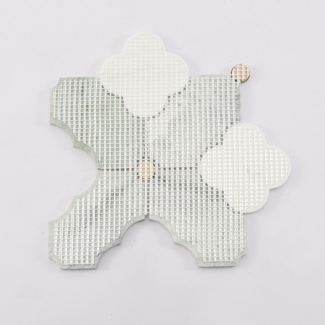 Back view of green white arabesque marble tile with fiber mesh backing