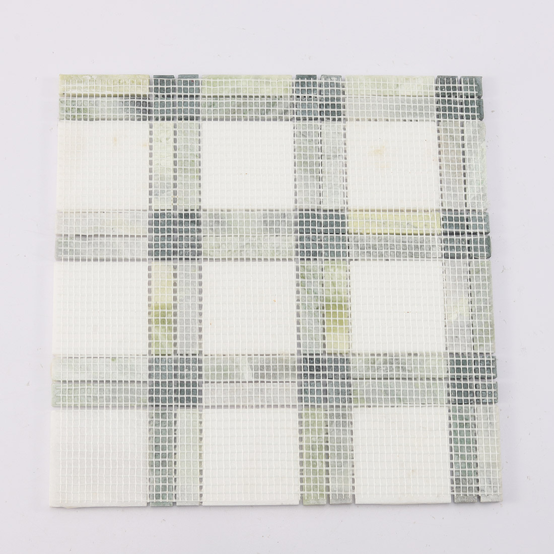 Back view of green and white marble mosaic tile sheet with fiber mesh backing