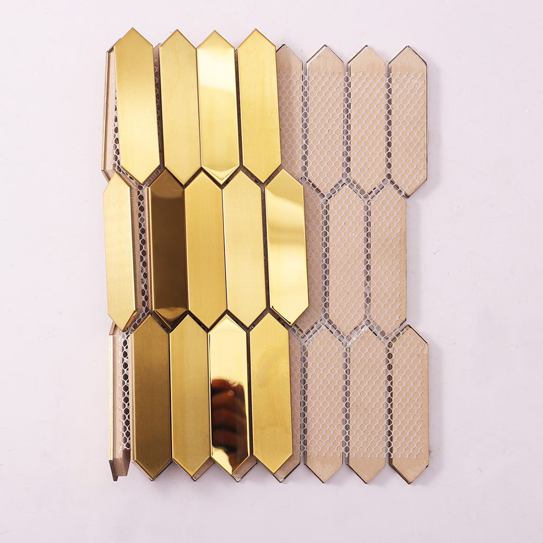 Side and mesh backing view of gold picket stainless steel mosaic tile sheet