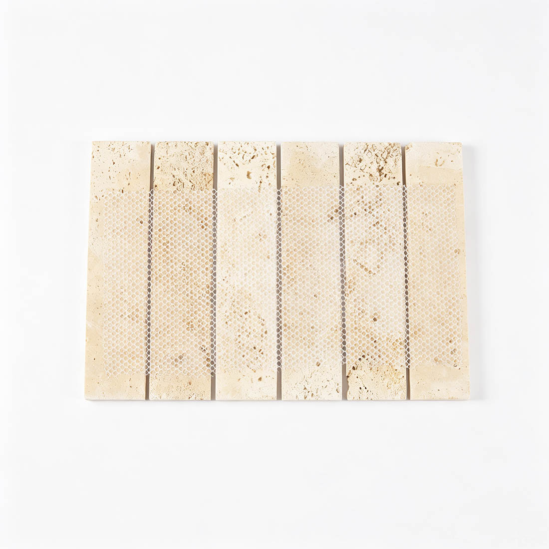 Mesh backing on the reverse side of beige travertine mosaic