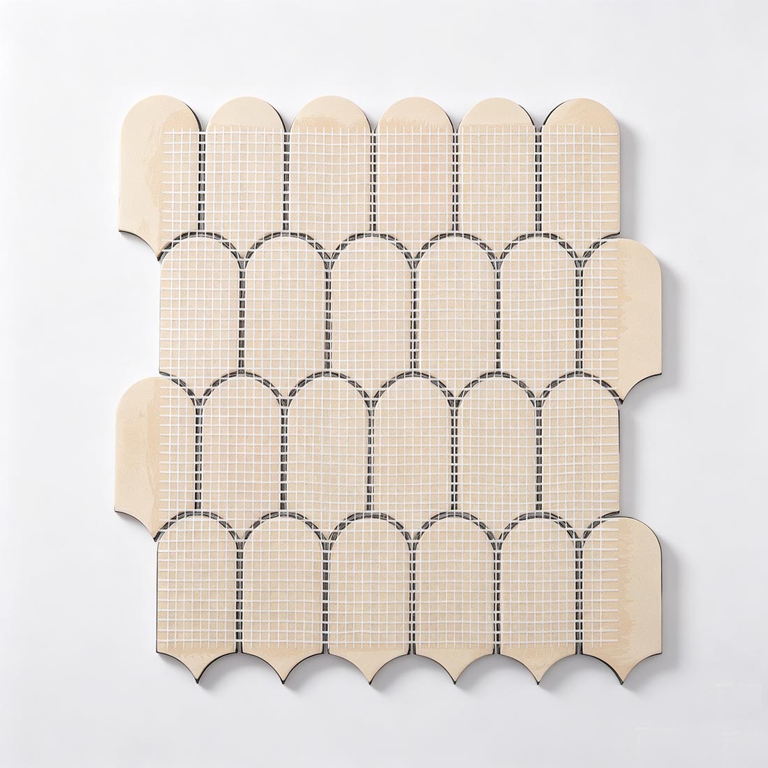 Mesh backing on reverse side of black scalloped stainless steel tile