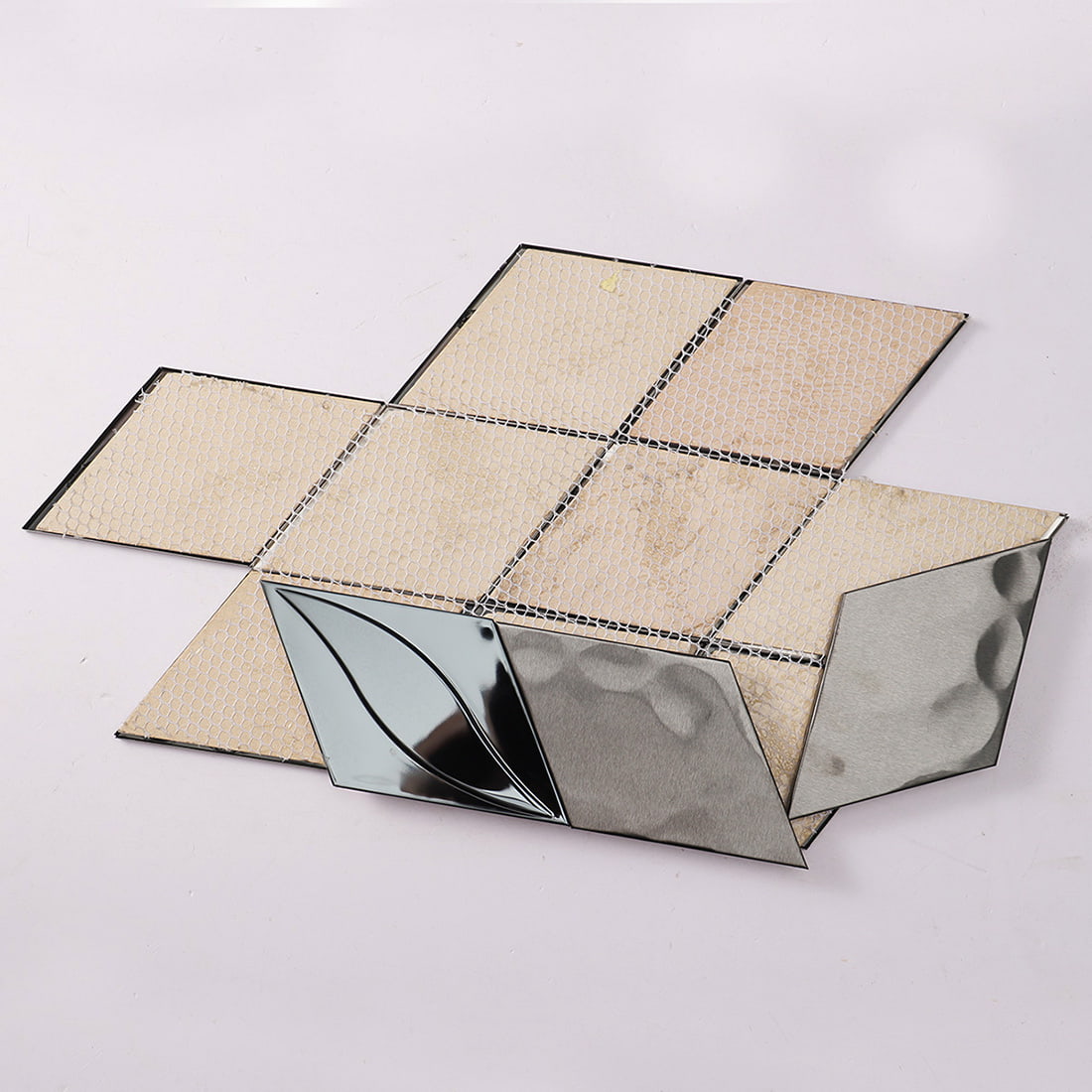Reverse side of the black stainless steel mosaic tile sheet showing the mesh backing.