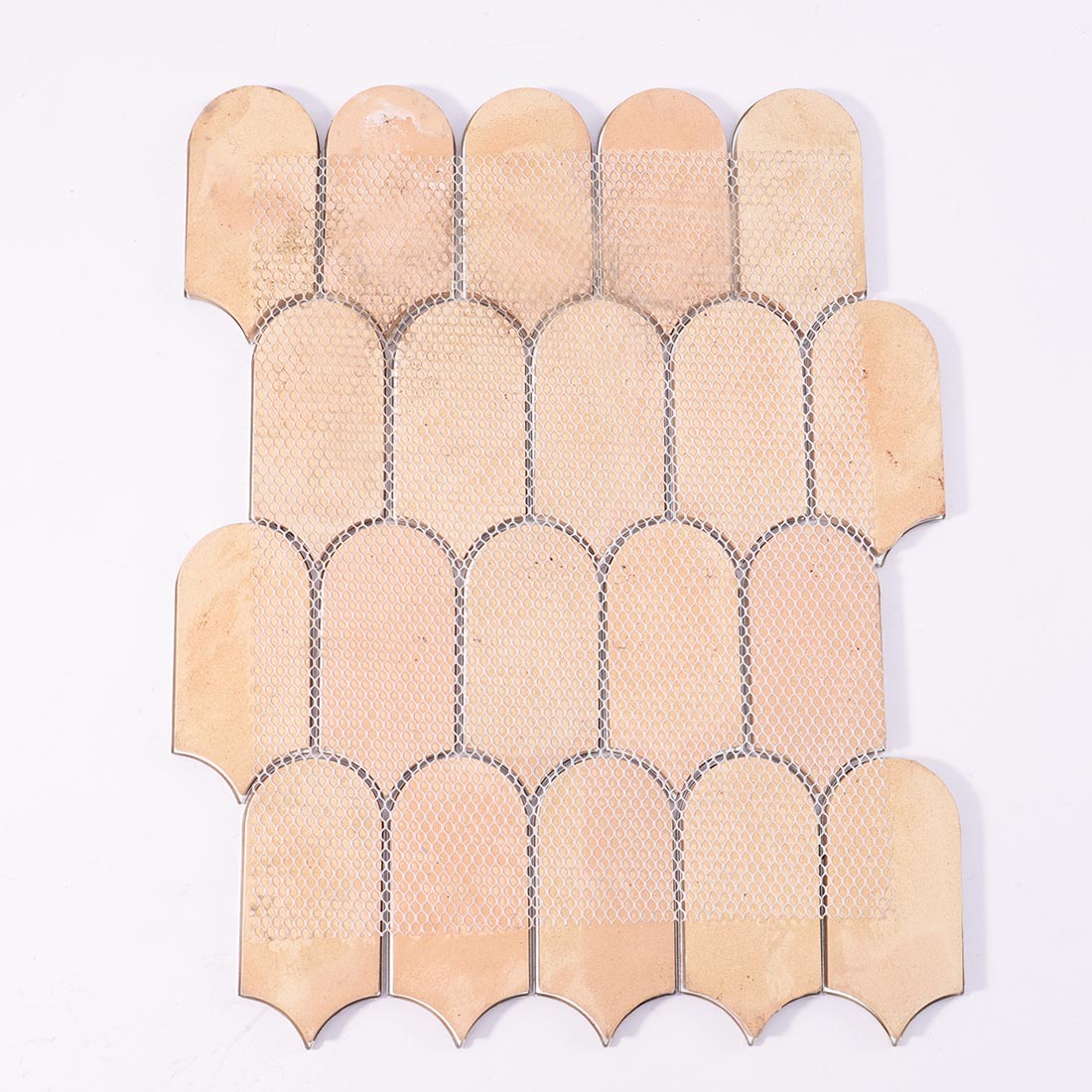 Mesh backing on reverse side of floral pattern arched aluminum mosaic sheet