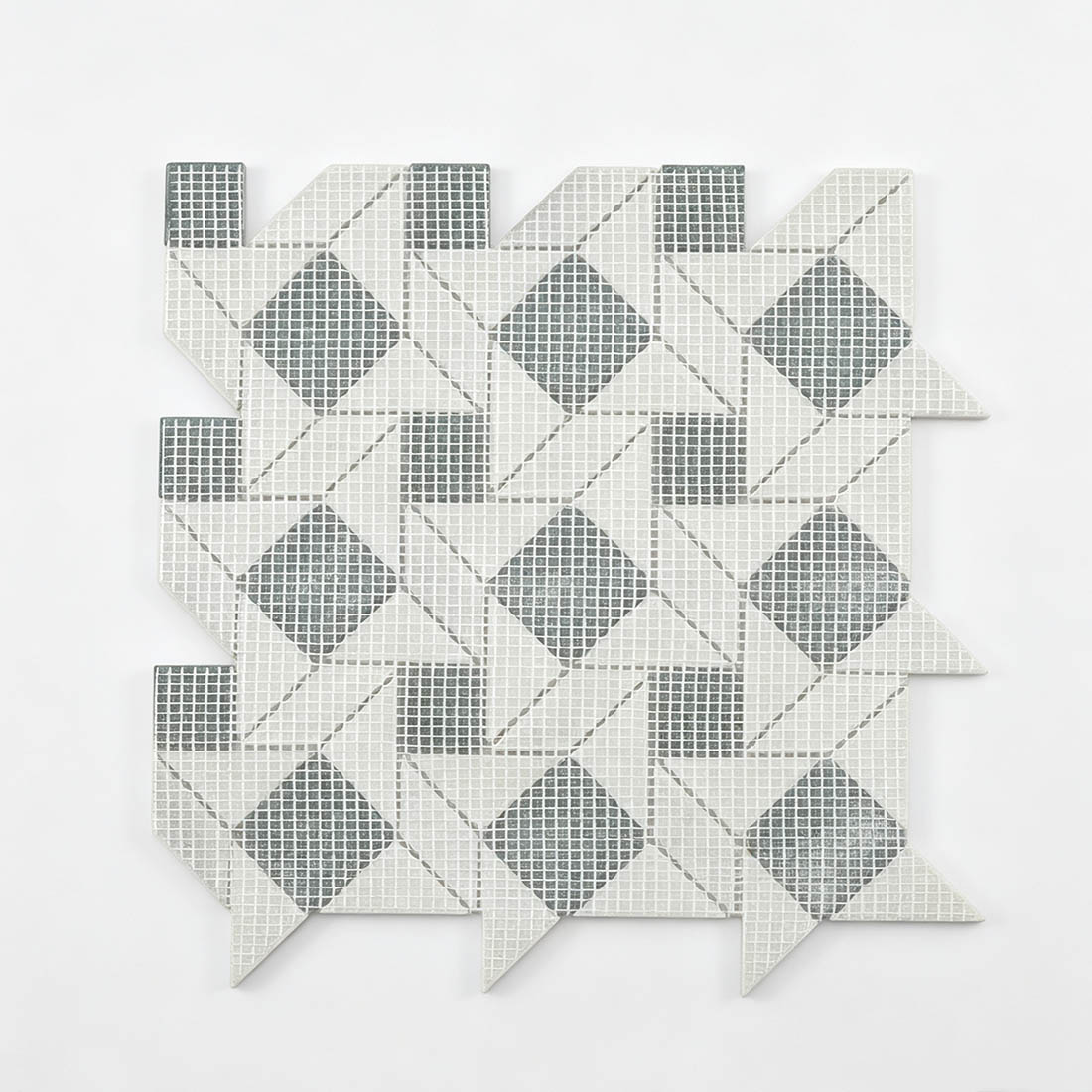 Mesh backing view of green and white geometric pinwheel marble mosaic tile.