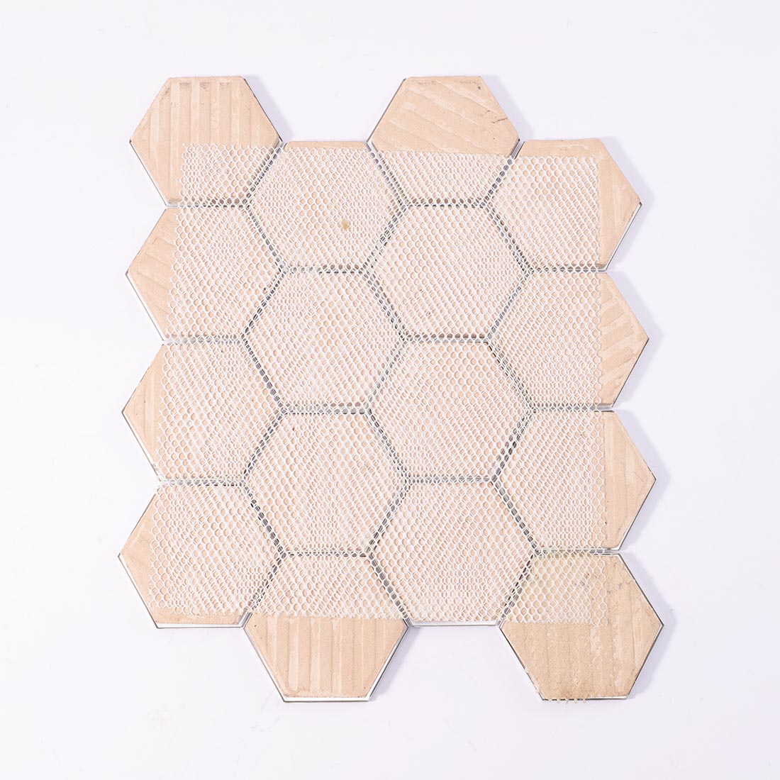 Mesh backing on reverse side of metallic grey hexagon aluminum mosaic sheet