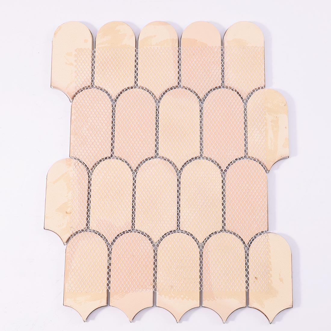 Mesh backing on reverse side of verdigris bronze arched aluminum mosaic sheet