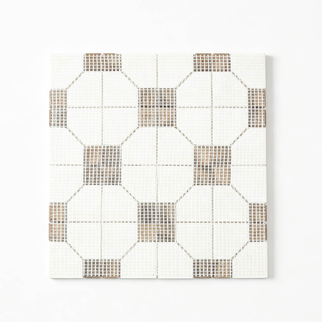 Mesh backing view of white and brown geometric marble mosaic tile.