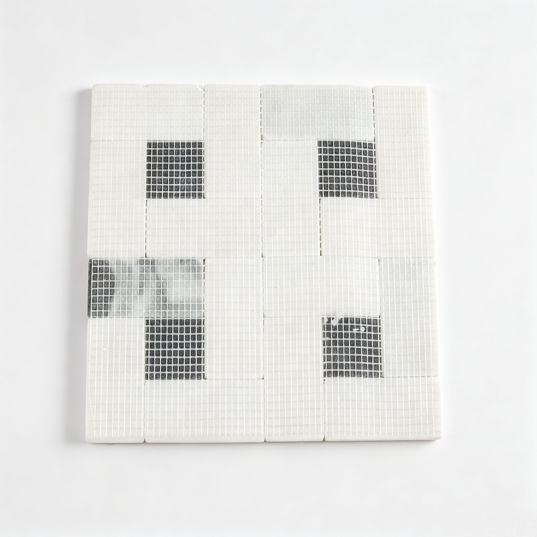 Mesh backing on the reverse side of white marble mosaic sheet
