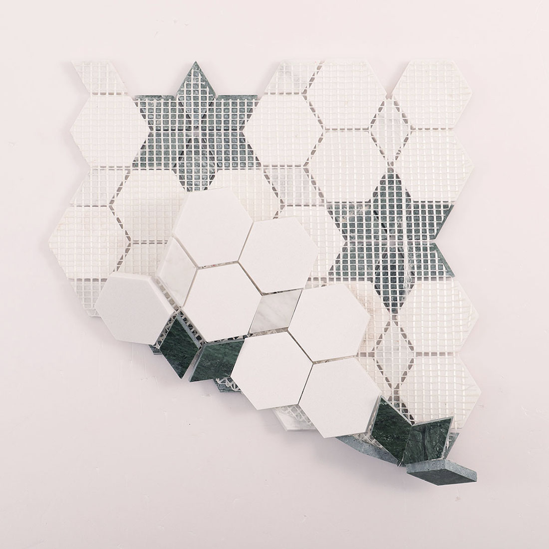 Back view of mesh-mounted white and green marble mosaic tile sheets.
