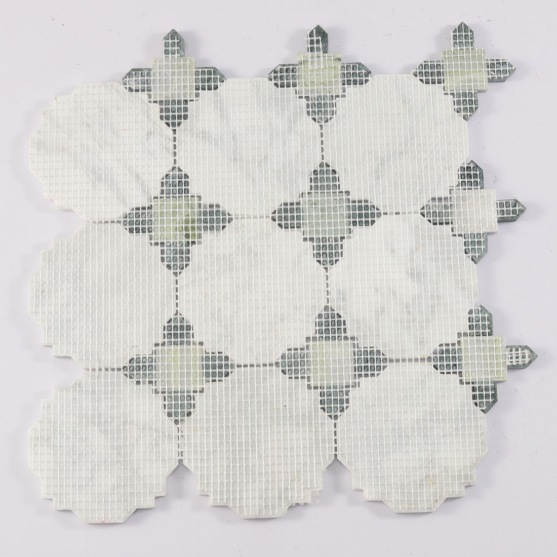 Back view of mesh mounted white octagon marble mosaic with green accent pieces