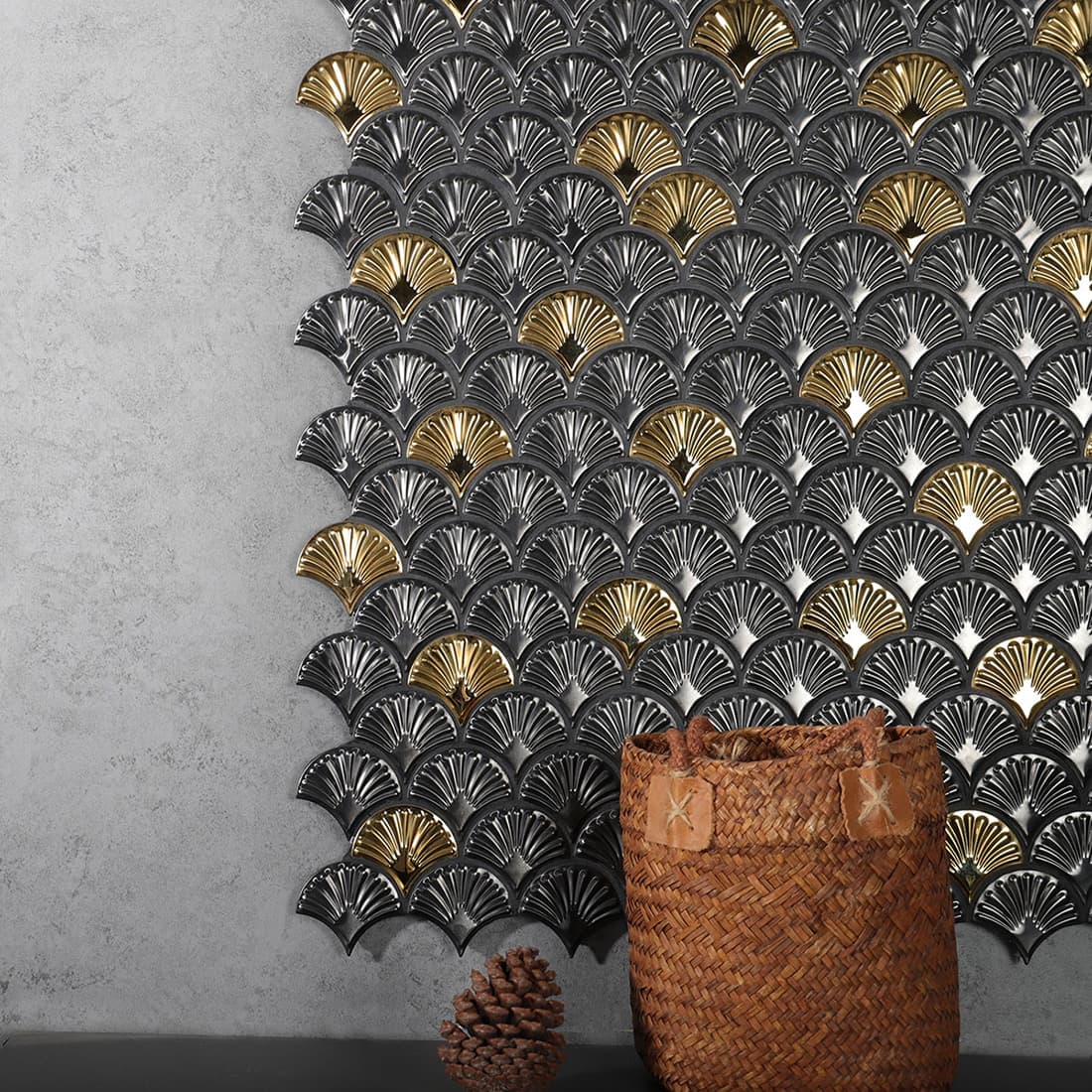 Metallic charcoal and gold fan mosaic tiles installed on a wall as a decorative backsplash.